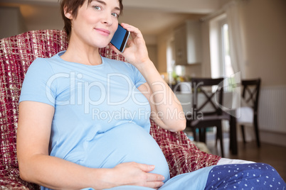 Pregnant woman making a call