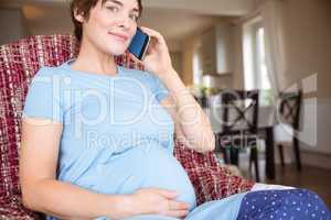 Pregnant woman making a call