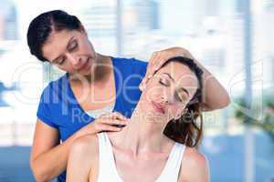 Therapist examining her patients neck