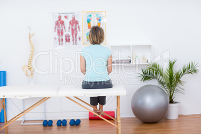 Woman sitting on massage table