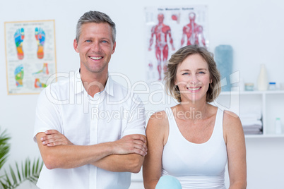 Doctor and patient smiling at camera