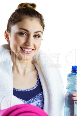 Fit brunette holding yoga mat