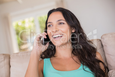 Pretty brunette calling with her mobile phone