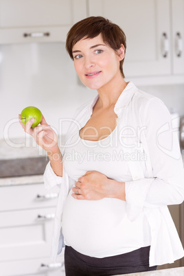 Pregnant woman eating an apple