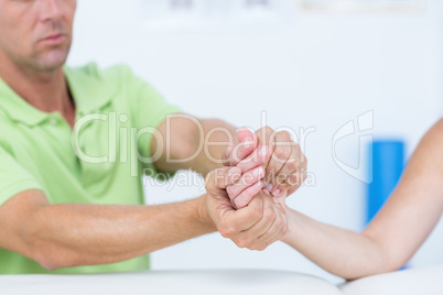 Doctor examining his patients hand