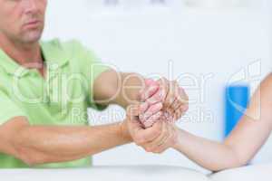 Doctor examining his patients hand