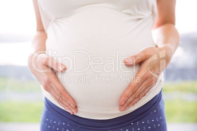 Pregnant woman holding her bump