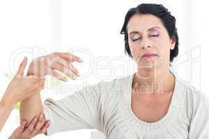 Therapist holding her patients arm