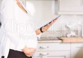 Pregnant woman using tablet pc