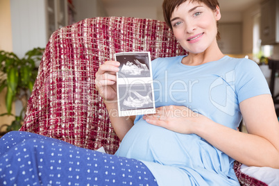 Pregnant woman looking at ultrasound scans