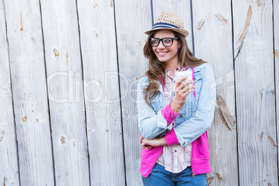 Cute woman holding disposable cup coffee