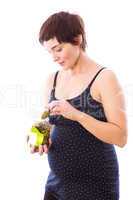 Pregnant woman eating jar of pickles