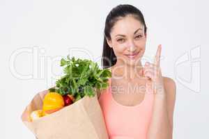 Slim woman holding bag with healthy food
