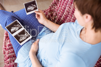 Pregnant woman looking at ultrasound scans