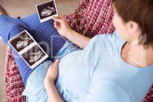 Pregnant woman looking at ultrasound scans