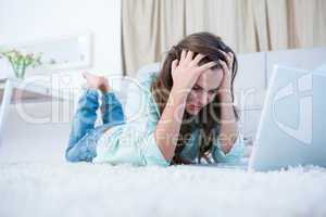 Worried woman using her laptop