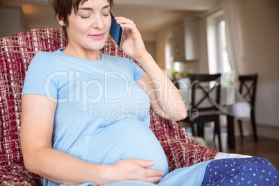 Pregnant woman making a call