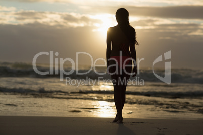 Sporty brunette walking on the beach