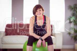 Fit woman sitting on exercise ball