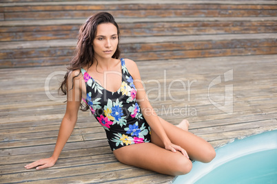 Pretty brunette sitting in swimwear