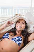 Pretty brunette relaxing on a hammock