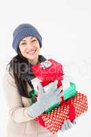 Happy brunette holding gifts
