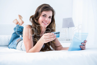 Beautiful woman doing online shopping with her tablet pc