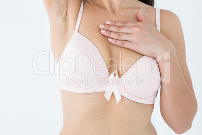 Woman in bra with breast cancer awareness ribbon