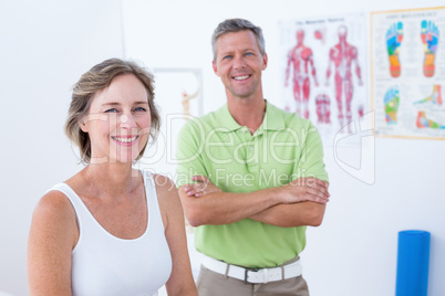 Doctor and patient smiling at camera