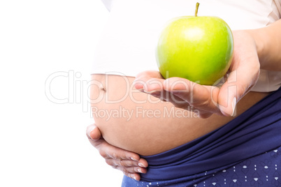 Pregnant woman holding green apple