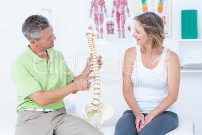 Doctor showing anatomical spine Doctor showing anatomical spine
