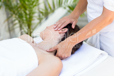 Brunette receiving neck massage