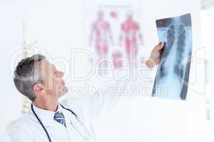 Thoughtful doctor holding xray