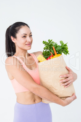 Slim woman holding bag with healthy food