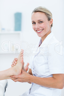 Physiotherapist doing foot massage