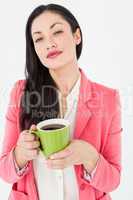 Smiling brunette holding coffee