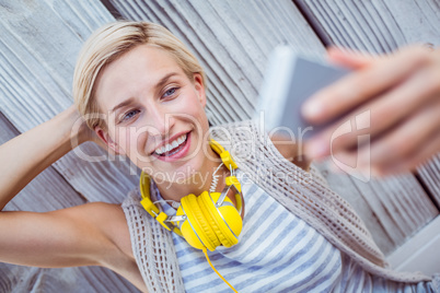 Pretty blonde woman taking selfie