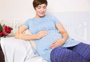 Pregnant woman relaxing on the couch