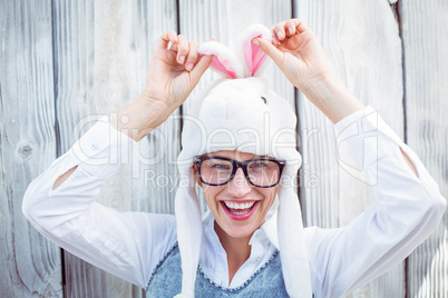 Pretty blonde woman smiling at the camera wearing funny hat