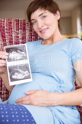 Pregnant woman looking at ultrasound scans