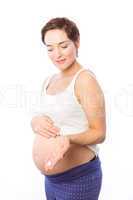 Pregnant woman showing body cream