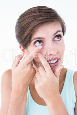 Pretty woman applying contact lens