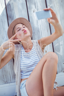 Pretty blonde woman taking selfie