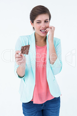 Woman choosing to eat chocolate or not