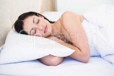 Pretty brunette sleeping on bed