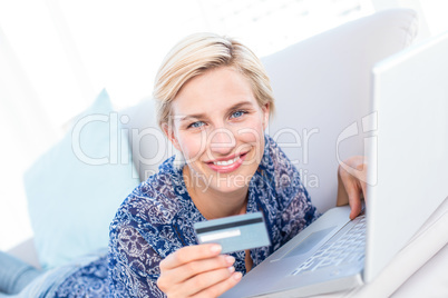 Pretty blonde woman doing online shopping