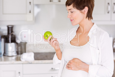 Pregnant woman eating an apple