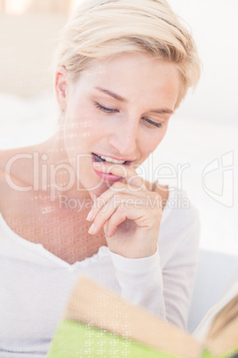 Smiling blonde woman reading a book