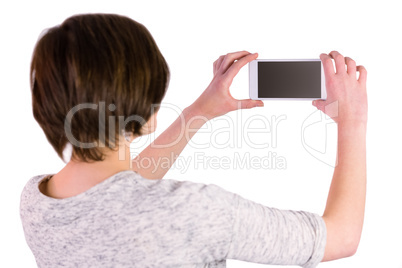 Pretty brunette taking a picture with her smartphone