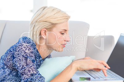 Pretty blonde woman doing online shopping